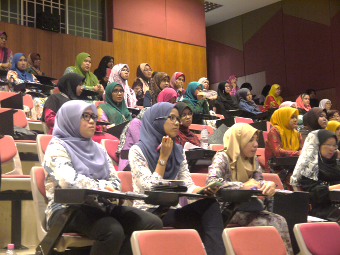 Participants focus on the lecture delivered by speaker